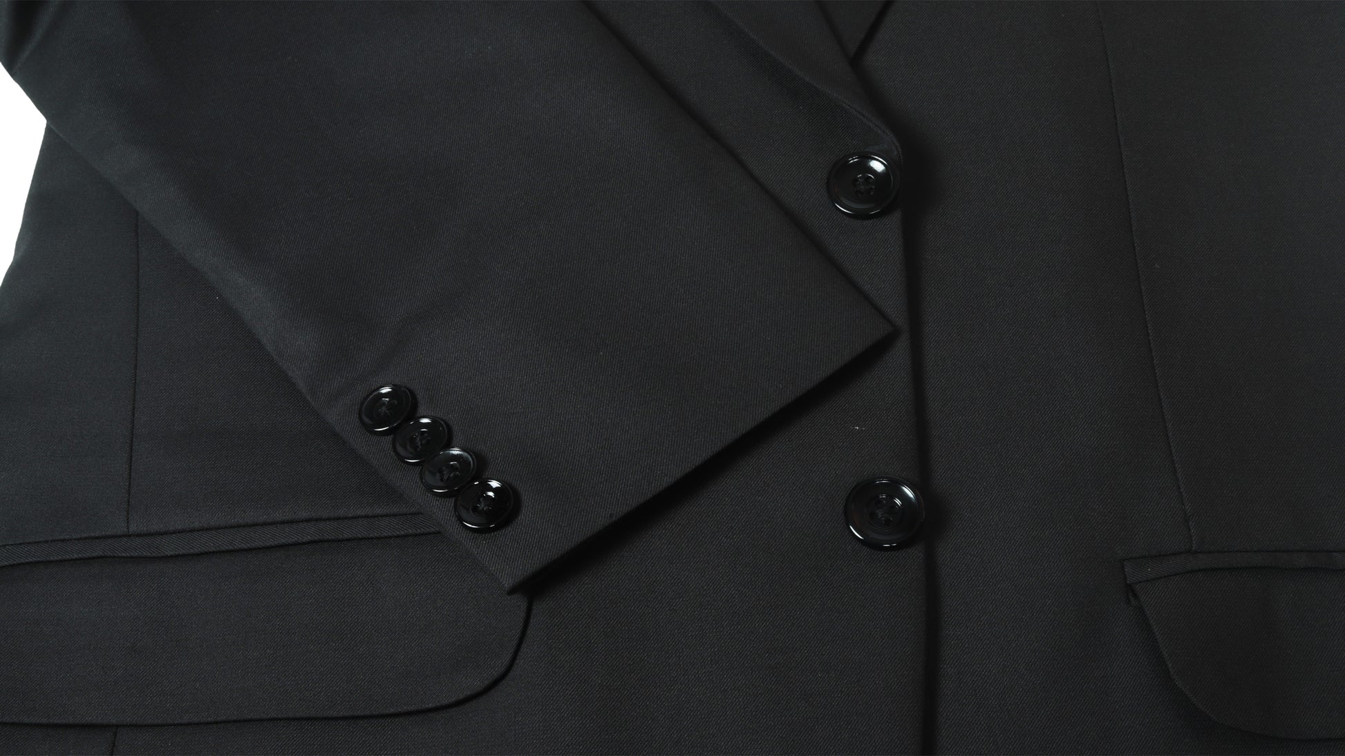 Close-up of a black coat with buttons on a white background