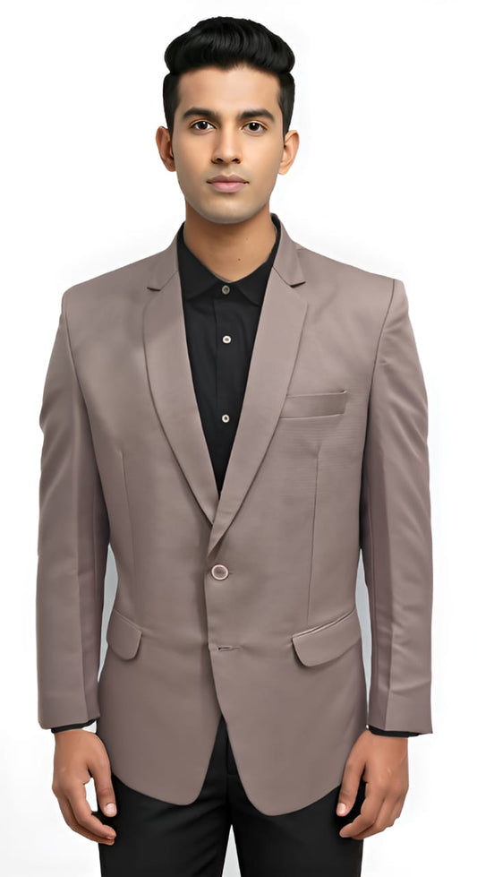 Man wearing a dusty mauve blazer over a black shirt on a white background