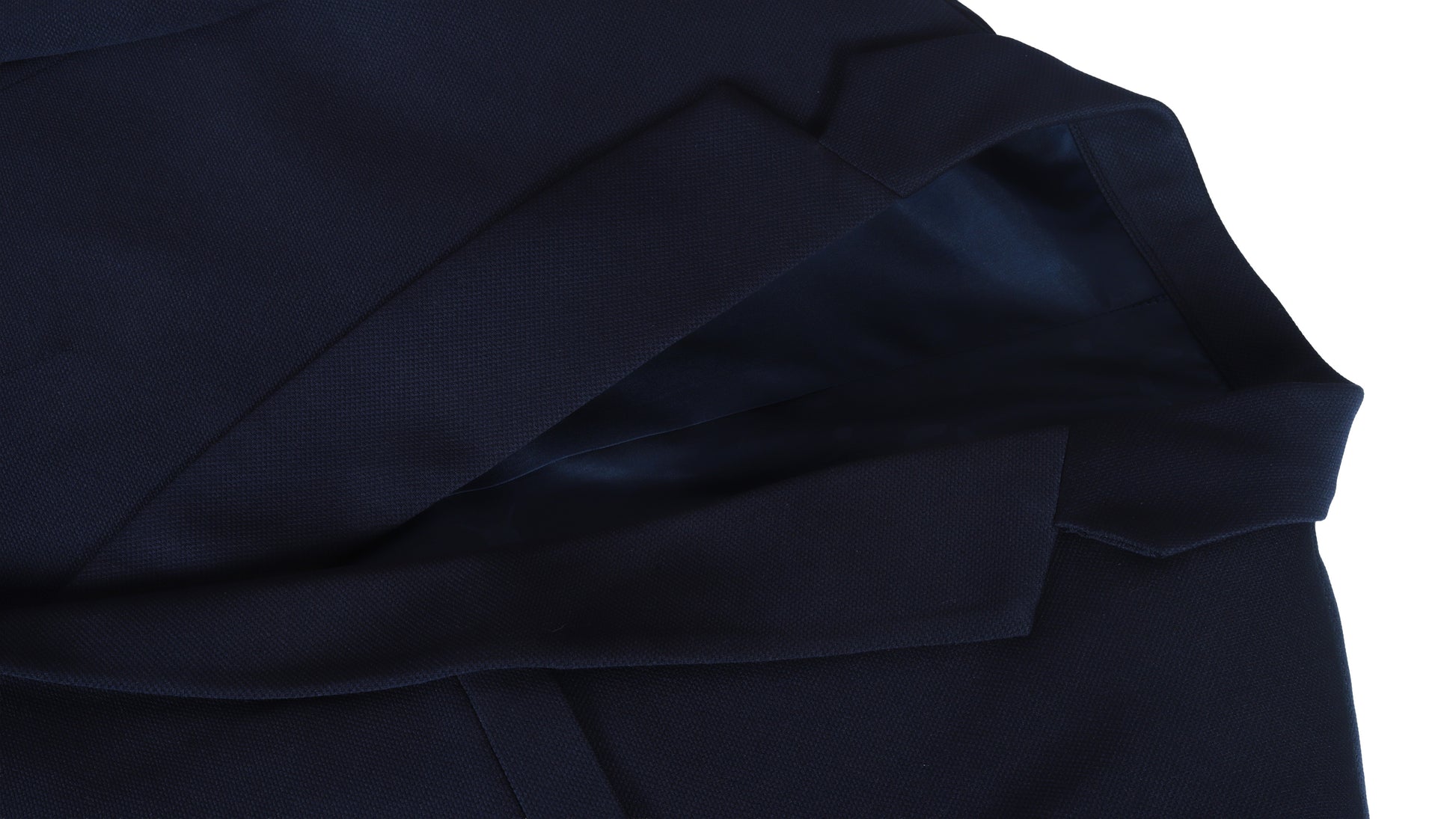 Close-up of a dark blue coat fabric texture on a white background