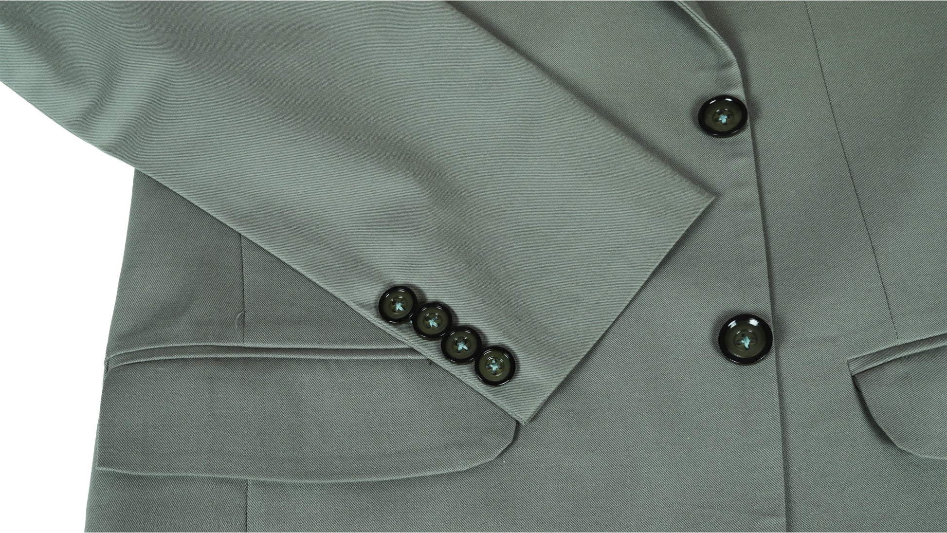 Close-up of a green suit jacket sleeve with buttons on a white background